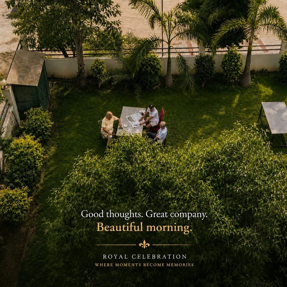 Guests seated at a table on the garden lawn in the morning