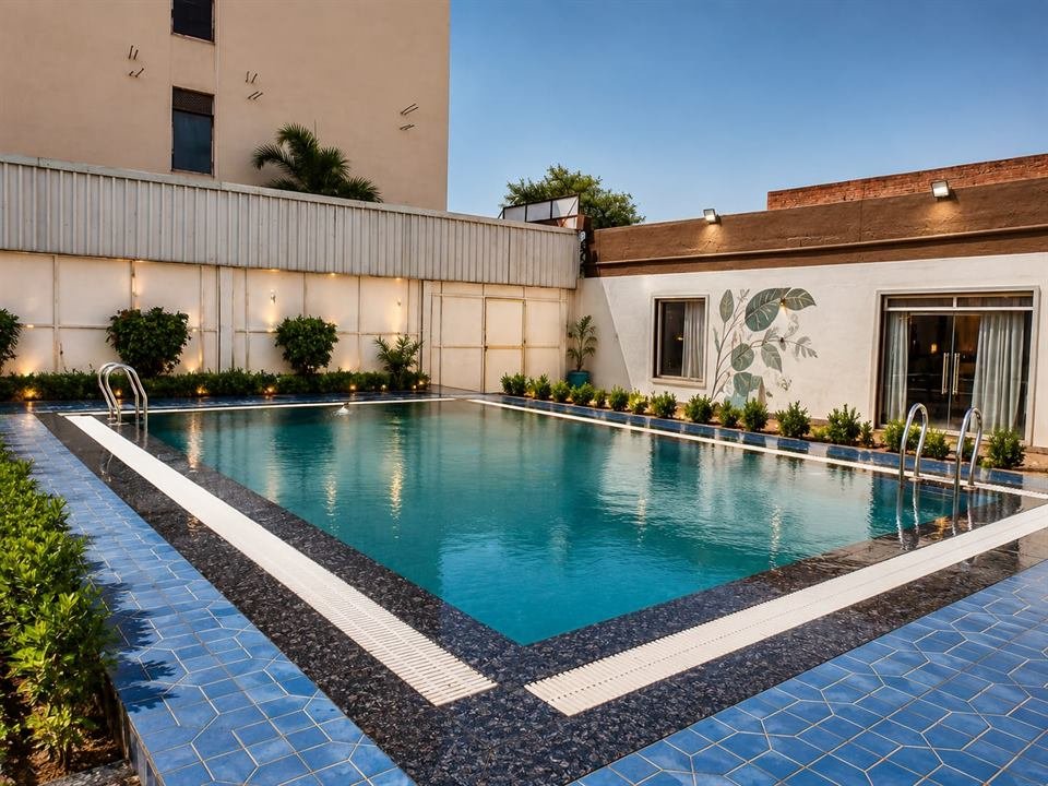 Swimming pool with blue tiled deck and wall mural